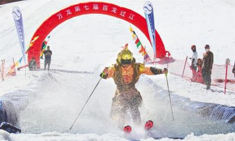 5月1日，萬龍滑雪場第七屆“百龍過江”活動現場，一名選手滑過水池。